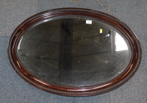 A mahogany framed oval wall mirror.
