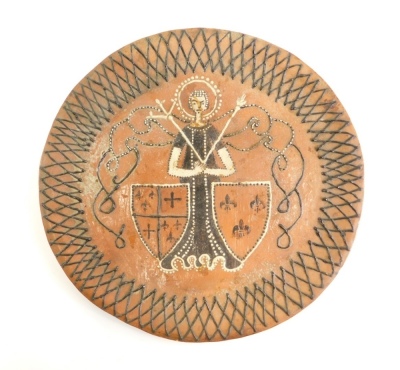 A 17thC style slipware charger, with a lattice work border, figure and two shield decoration and pudding bowl base, in the manner of Thomas Toft, unsigned, 35cm diameter.