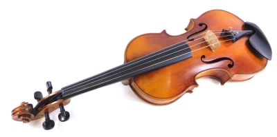 A 20thC violin, with two bows, one stamped P&H London in outer case, two piece back, the case 77cm wide.