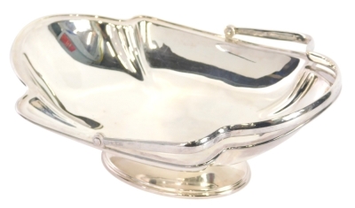 A George V silver basket, with angular swing handle, shaped body and oval foot, Sheffield 1923, 8cm wide, 22oz.