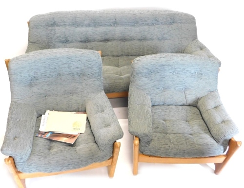 An Ercol Wychwood elm three piece suite, re-upholstered in grey fabric, the sofa 189cm wide. Purchased 1979 and sold with the brochure relating to the purchase. The upholstery in this lot does not comply with the 1988 (Fire & Fire Furnishing) Regulation