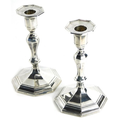 A pair of George V silver candlesticks, with baluster stems and octagonal bases, loaded London 1922, 18cm high, 28oz all in.