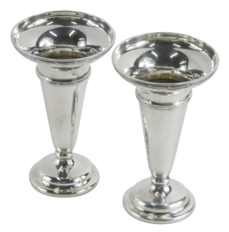 A pair of George V silver stem vases, by Hukin & Heath, with trumpet bodies, Birmingham 1922, loaded, 18cm high, 12oz all in.