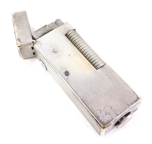 A mid-20thC Dunhill pocket lighter, with engine turned rectangular body, 6cm high.