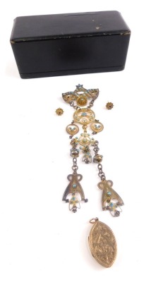 A highly elaborate Victorian style drop pendent, filigree design set with turquoise, with an arrangement of floral and scroll discs, with a plain pin back, cased, a silver gilt locket and a pair of floral ear studs. (a quantity)