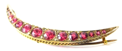 A 9ct gold crescent brooch, in the Edwardian style set with fifteen red paste stones.