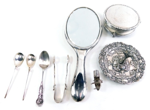 Various silver, an Edwardian ring stand, repousse decorated with scrolls and flowers, Birmingham, 1907, 10cm wide, a jewellery box, hand mirror, sugar tongs, spoons and an unmarked miniature boat, white metal, 16oz all in. (a quantity)