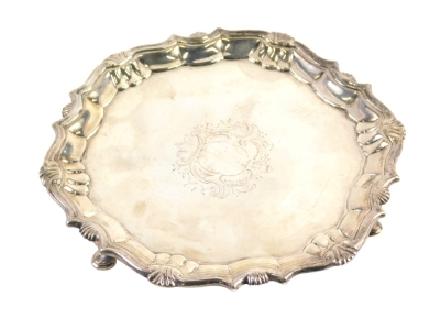 A George II silver waiter, by Robert Abercromby, with scroll and shell border, on triple hoof feet, centred by an etched cartouche, London 1750, 15cm wide, 6.94 oz.