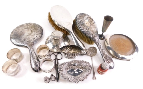 Silver and effects, an Edward VII silver pin dish, of heart shaped form with repousse decorated scrolls and piercing, Birmingham 1903, 10cm wide, various other items, napkin rings, scissors, silver topped jar, part dressing table sets, inkwell and a photo