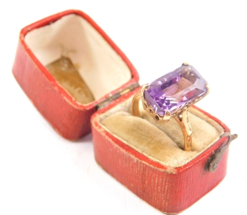 A 9ct gold dress ring, claw set with an amethyst coloured stone, ring size L, 3.4g all in.