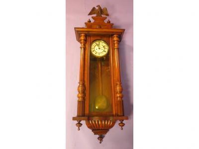 A Vienna type wall clock in a walnut veneered case with circular dial with