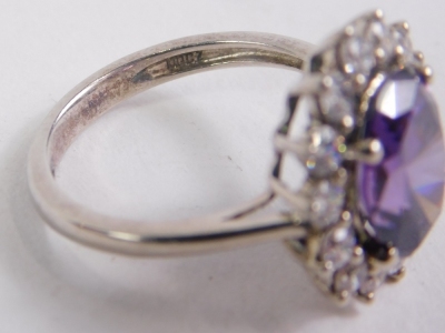 A dress ring, claw set with central purple stone, with floral surround of small diamonds on a part pierced shank, size M. - 2