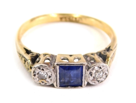 An 18ct gold dress ring, with baguette cut blue stone flanked by two small diamonds, size J, 2.3g.