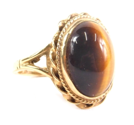 A 9ct gold tiger's eye dress ring, set with oval stone, size J, 4.1g all in.