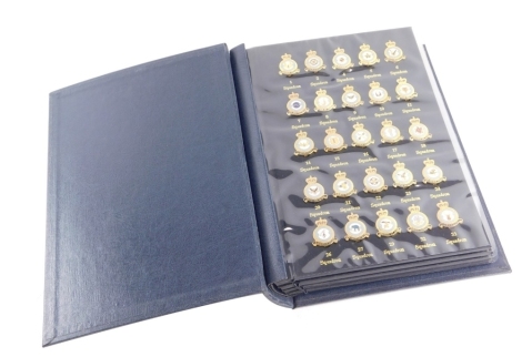 A Royal Air Force Museum album of gold plated pin badges, to include a collection of squadron pin badges. (one album)