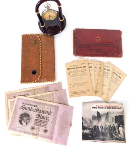 A war issue open faced pocket watch, marked GS/TP042438S, with crow's foot, 4cm diameter Arabic dial with subsidiary second hand and pierced pointers, with an associated watch stand with a quantity of various war related ephemera, books, notes, banknotes,