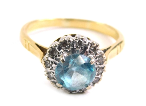 A blue zircon and diamond dress ring, illusion set with claw set central stone, marked 18ct, size M, 3.6g all in.