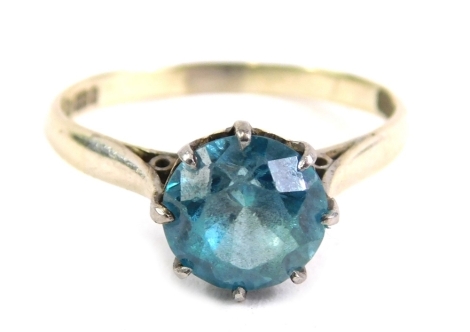 A 9ct white gold dress ring, claw set with blue zircon, size O, 2.6g all in.