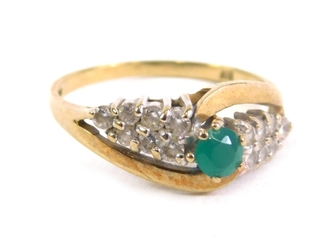 A 9ct gold dress ring, claw set with central green stone flanked by banks of white stones, size O, 2.3g all in.