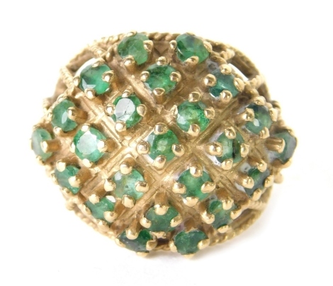 A 9ct gold filigree dress ring, claw set with small green stones in a basket setting, size M, 5.7g all in.