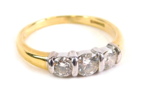 An 18ct gold three stone diamond ring, on plain shank, size M, 3.4g all in.