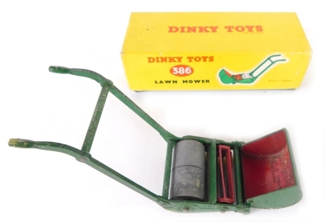 A Dinky Toys lawn mower, number 386, 10cm high, with grass box.