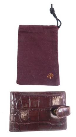 A Mulberry crocodile notebook, with paper pages and outer pouch, 12cm wide.