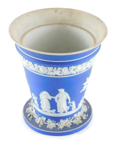 A Wedgwood dark blue Jasperware tapering vase, decorated with classical figures, with an upper floral border, impressed marks beneath, 14cm high.