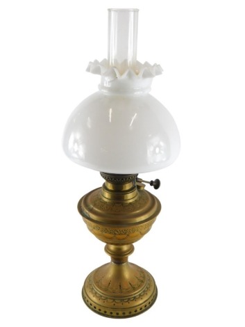 A brass oil lamp, with milk glass shade, clear reservoir and brass stem, 47cm high. (AF)