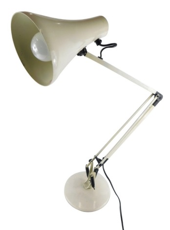 A metal framed Anglepoise lamp, on circular foot with cone shade, indistinct label, 67cm high.