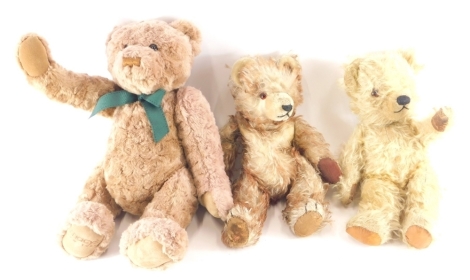 Various teddy bears, a Macy's New York plush jointed bear in cinnamon, 33cm high, a mid 20thC blonde plush jointed teddy bear, and another with straw filled miniature teddy bear in the manner of Deans. (3)