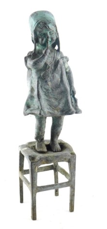 Early 20thC School, figure of a girl standing on stool, with hand to mouth, bronze, 30cm high.