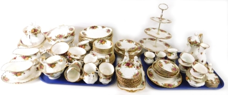 A comprehensive Royal Albert Old Country Roses part dinner service, with oval meat plate, 40cm wide, lidded tureen, dinner plates, gravy boat on stand, three tier cake stand, pair of vases, cruet, hand bell, six plates, coffee pot, teapot, bowl, sandwich 