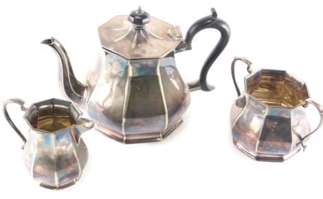 A three piece silver plated tea service, comprising teapot, two handled sugar bowl and milk jug, 9cm high.