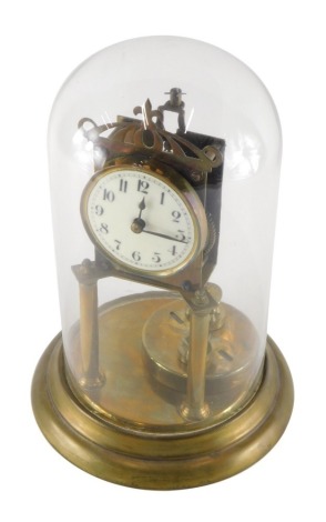 A 20thC anniversary clock, the 8cm diameter dial with Arabic numerals, surmounted by a pierced finial, on cylindrical supports under glass dome, on circular foot, 31cm high.