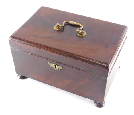 An early 19thC mahogany apothecary box, with brass handle, the hinged lid revealing a fitted interior, on compressed bun feet, with elaborate escutcheon and key, 18cm high, 28cm wide, 18cm deep.