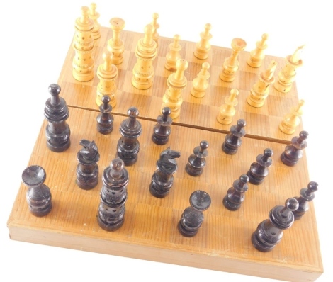 A 20thC carved wooden chess set, with 10cm high white king, in box inset with board.