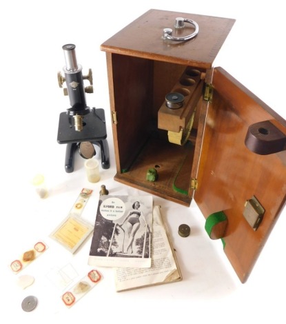 A 20thC student's microscope, the case with chrome handle marked 9481, containing a metal microscope with S scroll stand and chrome mounts, the case 38cm high.