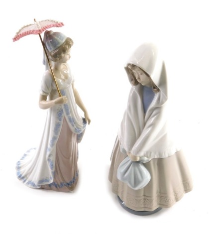 A Lladro figure of a lady holding parasol, B21N, marked beneath, and a Nao figure of a girl in shawl with forlorn expression, 18cm high. (2)