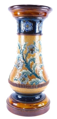 An early 20thC Doulton Lambeth stoneware plant stand, of baluster form raised with flowers on circular foot, impressed marks beneath, 47cm high, the top 22cm diameter. (AF)