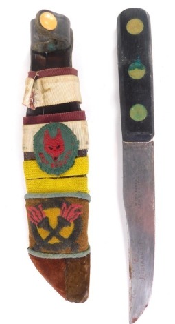 A mid 20thC Boy Scout's dagger, in sheath with Boy Scouts fox head badge, with plain blade and turned handle, 24cm long.