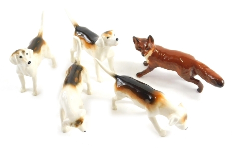 Four various Beswick hounds, and a Beswick fox, 5cm high, printed marks beneath.