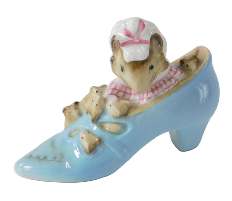 A Beatrix Potter figure The Old Woman Who Lived in a Shoe, gold oval mark beneath, 7cm high.