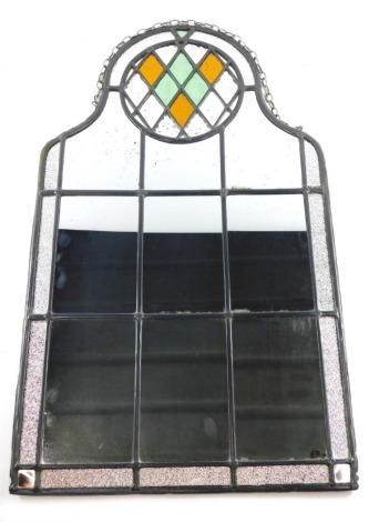 A 20thC lead glass mirror, with colour glass diamond shaped upper section and panels beneath, of shaped outline, 61cm x 38cm.