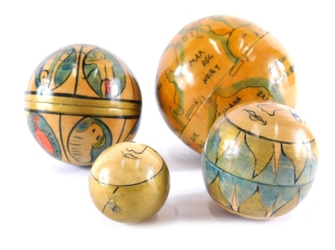 A treen miniature globe set, with screw opening, revealing smaller globes, the largest 7cm diameter.