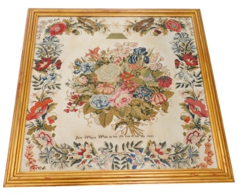 A Victorian pictorial sampler, by Jane Wray, aged 12, 1843, centred with a bouquet of flowers with a floral border, glazed and framed, 62cm x 64cm..