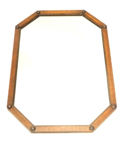 A 1920's oak rectangular wall mirror, with canted corners, 74cm wide.