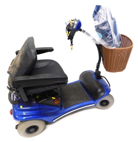 An Eden Mobility four wheeled mobility scooter, with front basket, power charger and canvas bag, 98cm high.