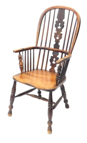 A 19thC ash and elm Windsor armchair, with a pierced splat, solid seat on turned legs with H stretcher.