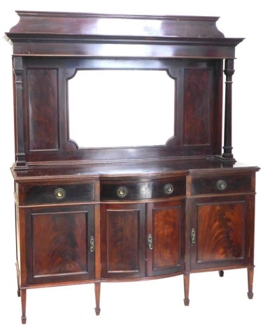 An early 20thC mahogany mirror back sideboard, the top with a moulded cornice above a bevelled plate, the base with a bowfronted centre section above three drawers and four panelled doors, on square tapering legs with spade feet, 166cm wide.